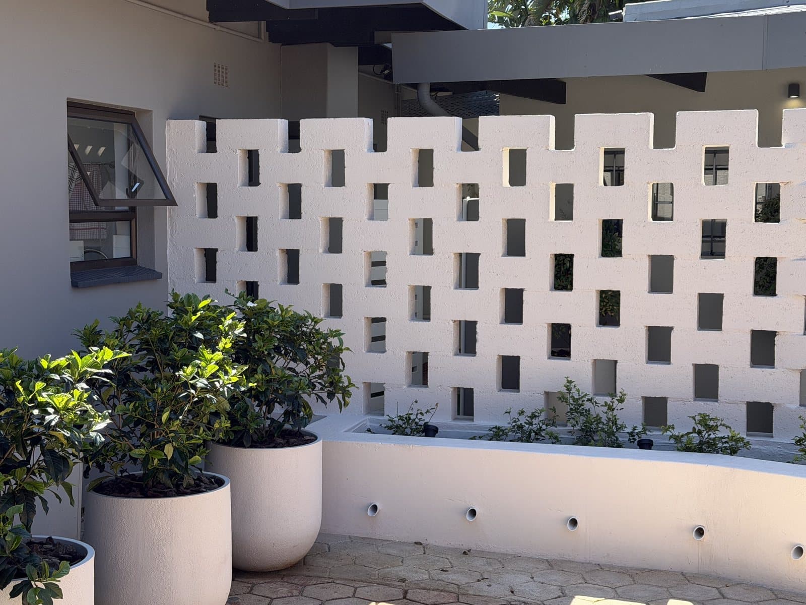 The practice’s sunny courtyard with potted plants